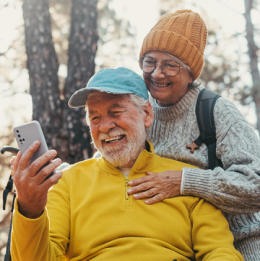 Senior man and woman smiling into man's phone