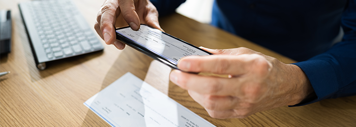 Man scanning a check with his smartphone